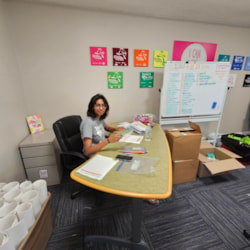 A volunteer works at a desk in the Girls on the Run office